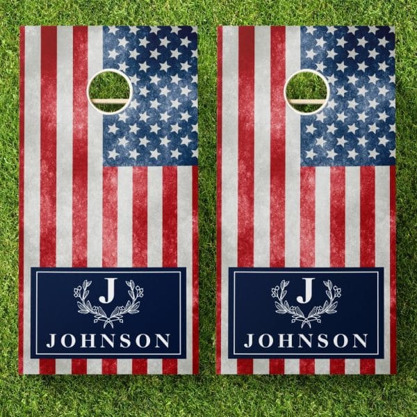 A Pair Of Cornhole Boards Decorated With A Distressed American Flag Design And Personalized With The Initial J And The Last Name Johnson.