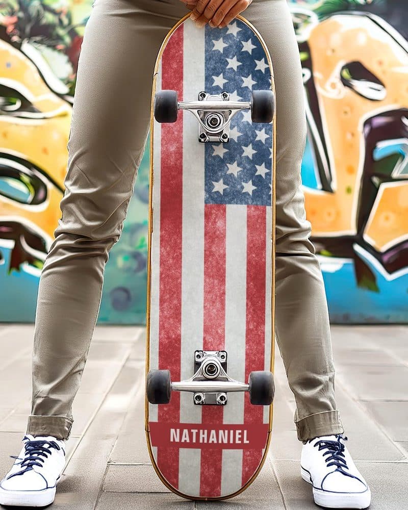 Person holding a skateboard with a distressed American flag design and the name Nathaniel at the bottom.