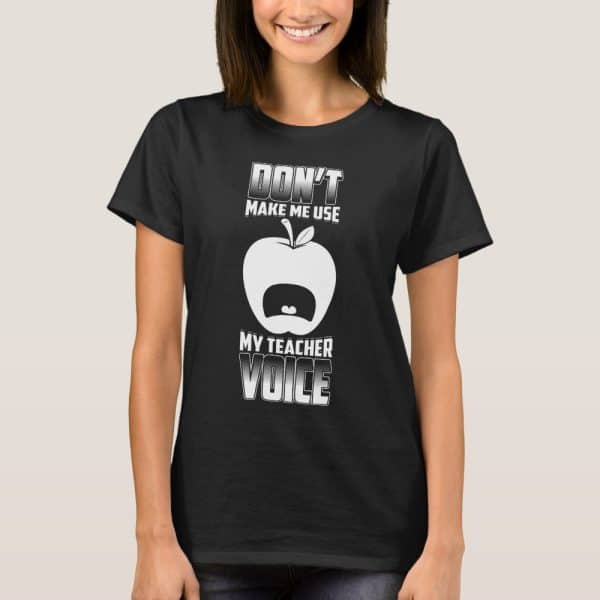 Woman Wearing A Black T-Shirt That Says Dont Make Me Use My Teacher Voice With An Illustration Of An Apple With A Mouth.