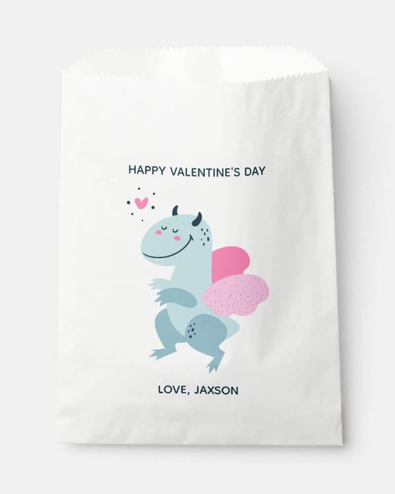 White Valentine's Day gift bag featuring a cute, light-blue dragon with pink wings.