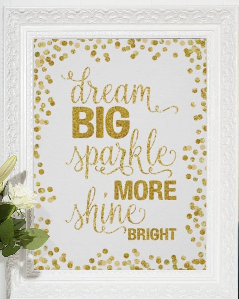 White frame with gold glitter lettering on a white background; the text reads Dream Big Sparkle More Shine Bright.