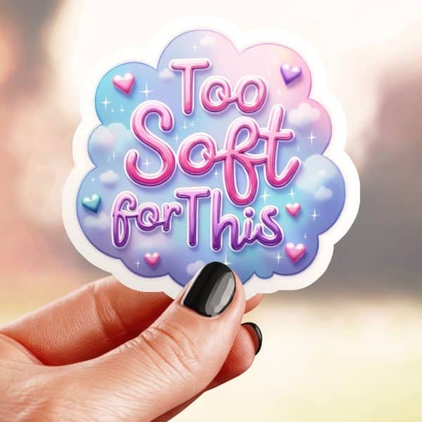 Hand Holding A Sticker That Says Too Soft For This In A Pastel Pink And Purple Cloud Design.