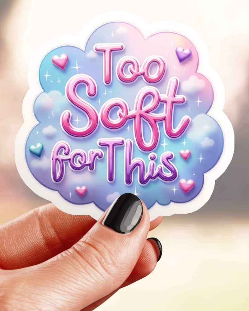 Hand holding a sticker that says Too Soft for This in a pastel pink and purple cloud design.