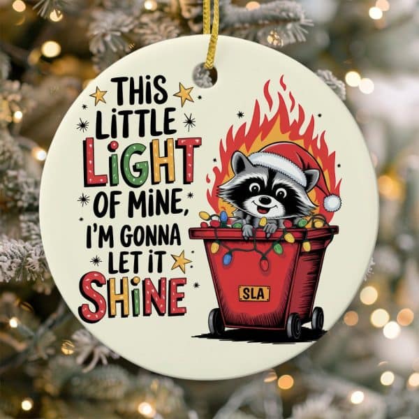 Christmas Ornament Featuring A Raccoon Wearing A Santa Hat In A Red Container With Christmas Lights, Surrounded By Flames. Text Reads &Quot;This Little Light Of Mine, I'M Gonna Let It Shine&Quot;.