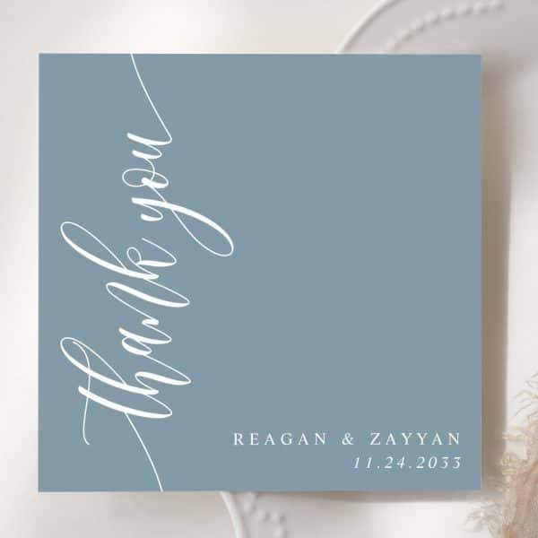 Dusty Blue Thank You Card With Elegant Script Lettering. Names And Wedding Date Are At The Bottom.