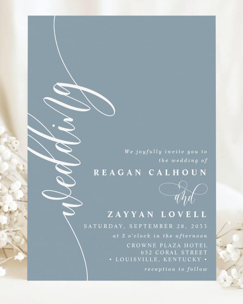 A dusty blue wedding invitation for Reagan Calhoun and Zayyan Lovell.