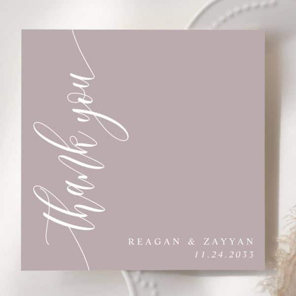 A Dusty Rose Thank You Card With White Script Lettering And The Names Reagan &Amp; Zayyan And Date 11.24.2033.