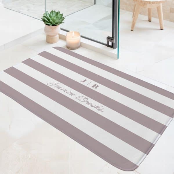 A Mauve And White Striped Bath Mat With The Initials Jb And The Name Jasmine Brooks Printed On It.