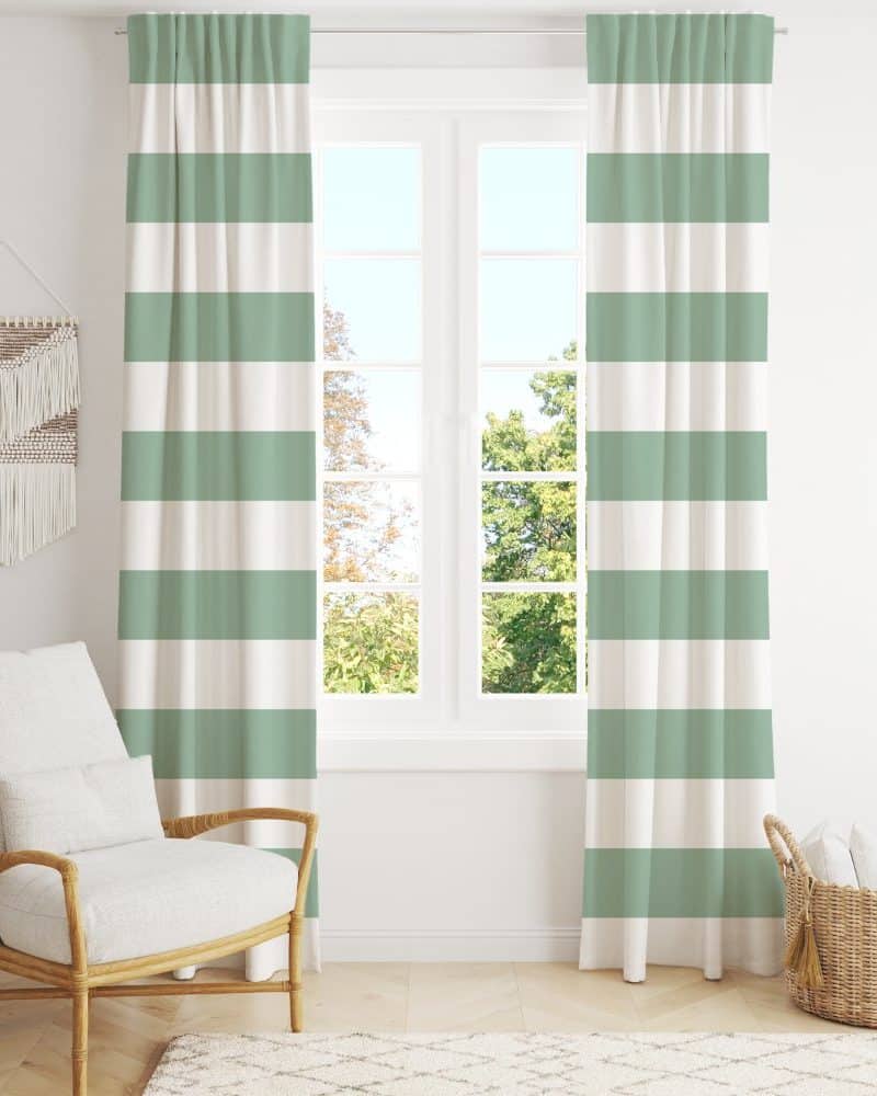Sage green and white striped curtains hanging in a window.