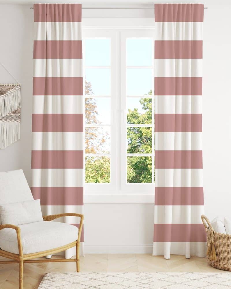 Pink and white striped curtains hanging in a window.