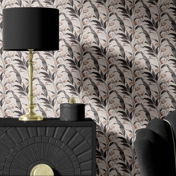 Black And Gold Lamp And Decorative Box On A Black Dresser Against A Floral Wallpaper.