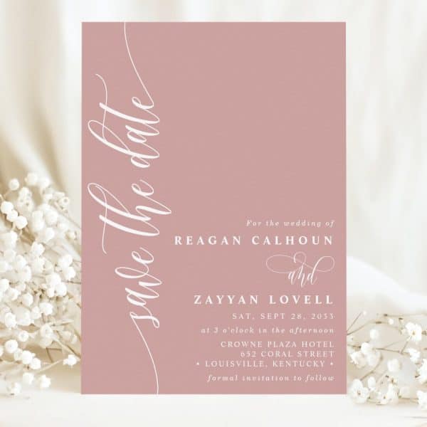 Dusty Rose Save The Date Card With Elegant Script Announcing The Wedding Of Reagan Calhoun And Zayyan Lovell.