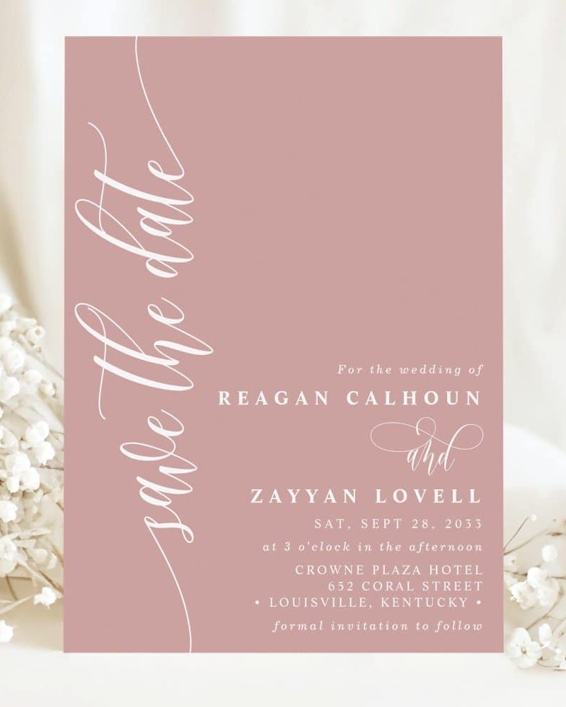 Dusty rose save the date card with elegant script announcing the wedding of Reagan Calhoun and Zayyan Lovell.