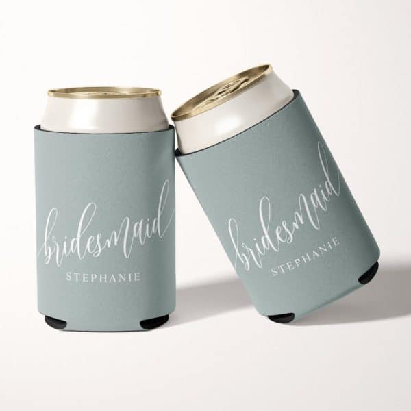 Two Light Blue Can Coolers With The Word Bridesmaid And A Name, Stephanie, In White Script.