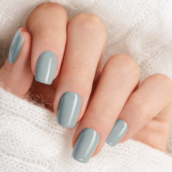 Close-Up Of A Hand With Light Grey Nail Polish.