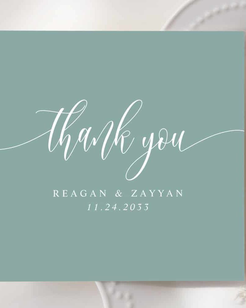 A light teal thank you card with white script lettering. The names Reagan & Zayyan and the date 11.24.2033 are also in white.