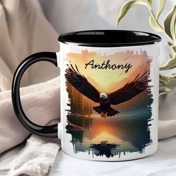 A Black-Handled Mug With A Personalized Design Featuring A Bald Eagle In Flight Over A Sunset Lake. The Name Anthony Is Printed On The Mug.