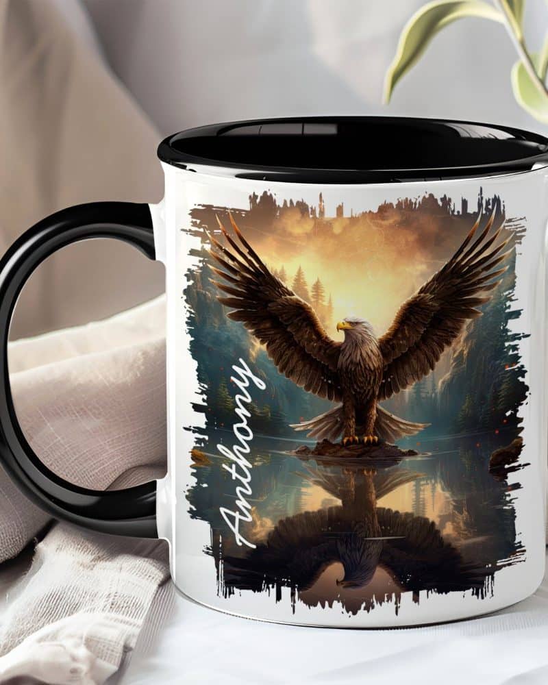 Black-handled mug with a personalized name, Anthony, and an image of a majestic eagle with wings spread wide, reflected in calm water at sunset.