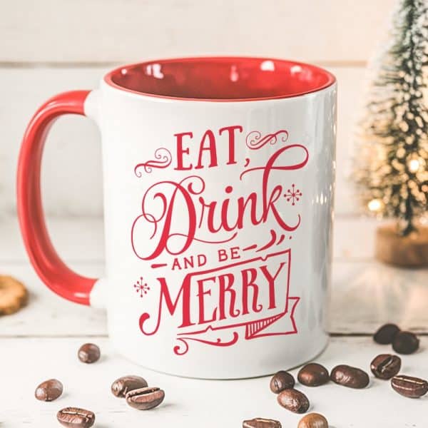 White Coffee Mug With Red Interior And Handle, Displaying Red Script That Reads Eat, Drink, And Be Merry.
