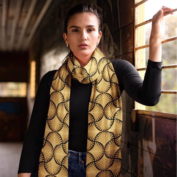 Woman Wearing A Gold And Black Patterned Scarf.
