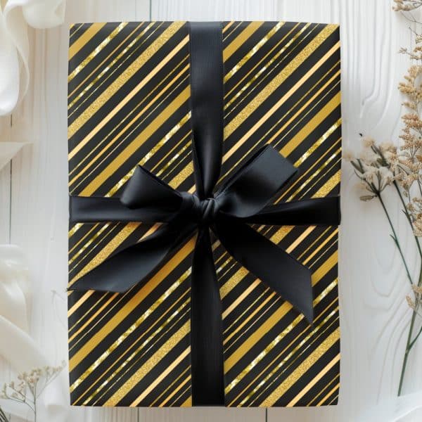 Black Gift Box With Gold Diagonal Stripes And A Black Ribbon.