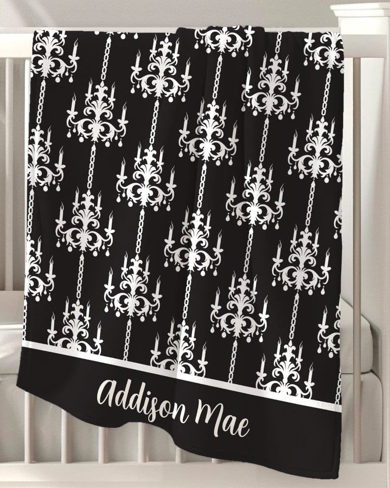 Black baby blanket with a white chandelier pattern and personalized name, Addison Mae.