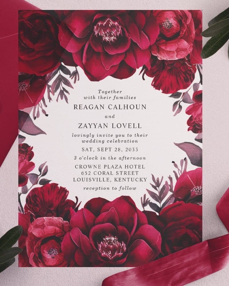 Wedding invitation with dark red floral border.