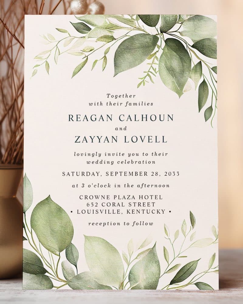 Wedding invitation with watercolor greenery border, announcing the marriage of Reagan Calhoun and Zayyan Lovell.