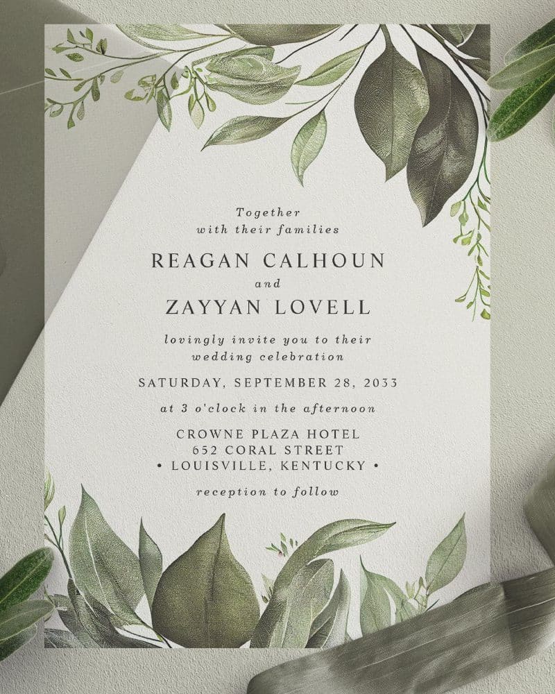 Wedding invitation for Reagan Calhoun and Zayyan Lovell, featuring a leafy botanical design.