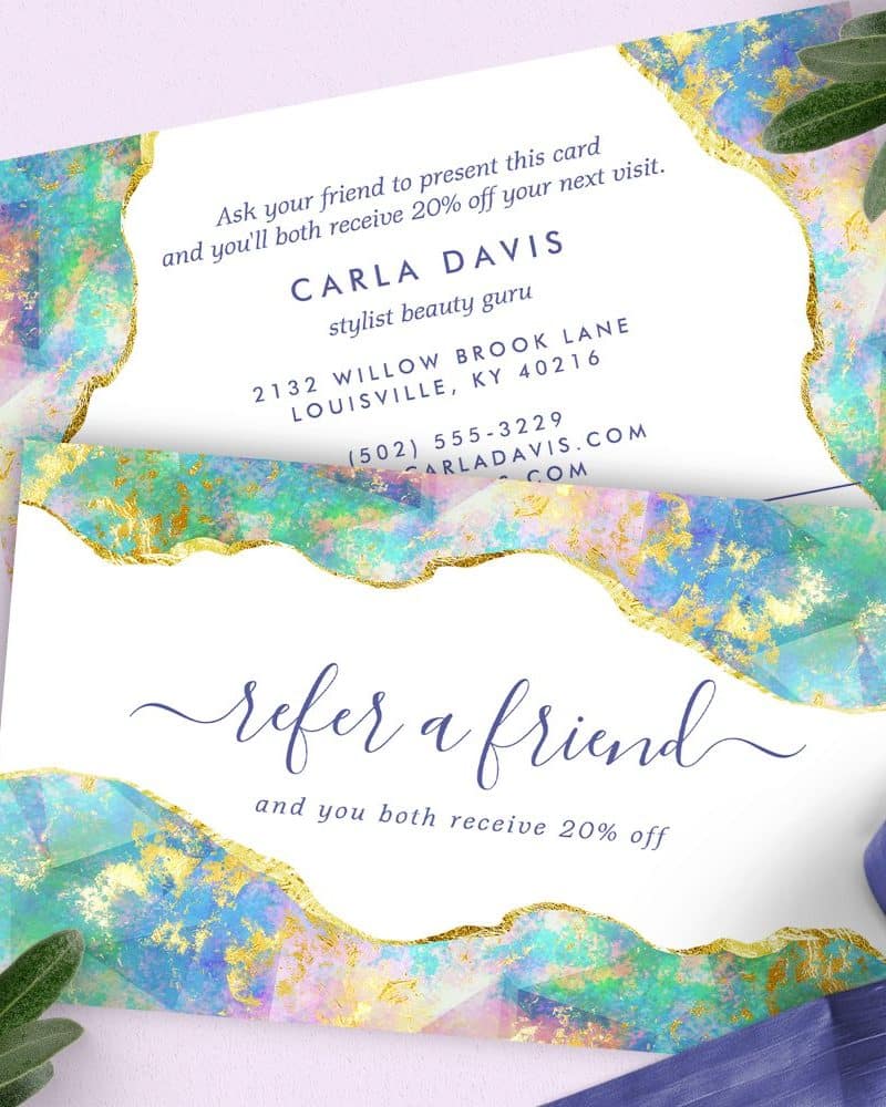 Referral card for Carla Davis, stylist, featuring an abstract pastel and gold design.