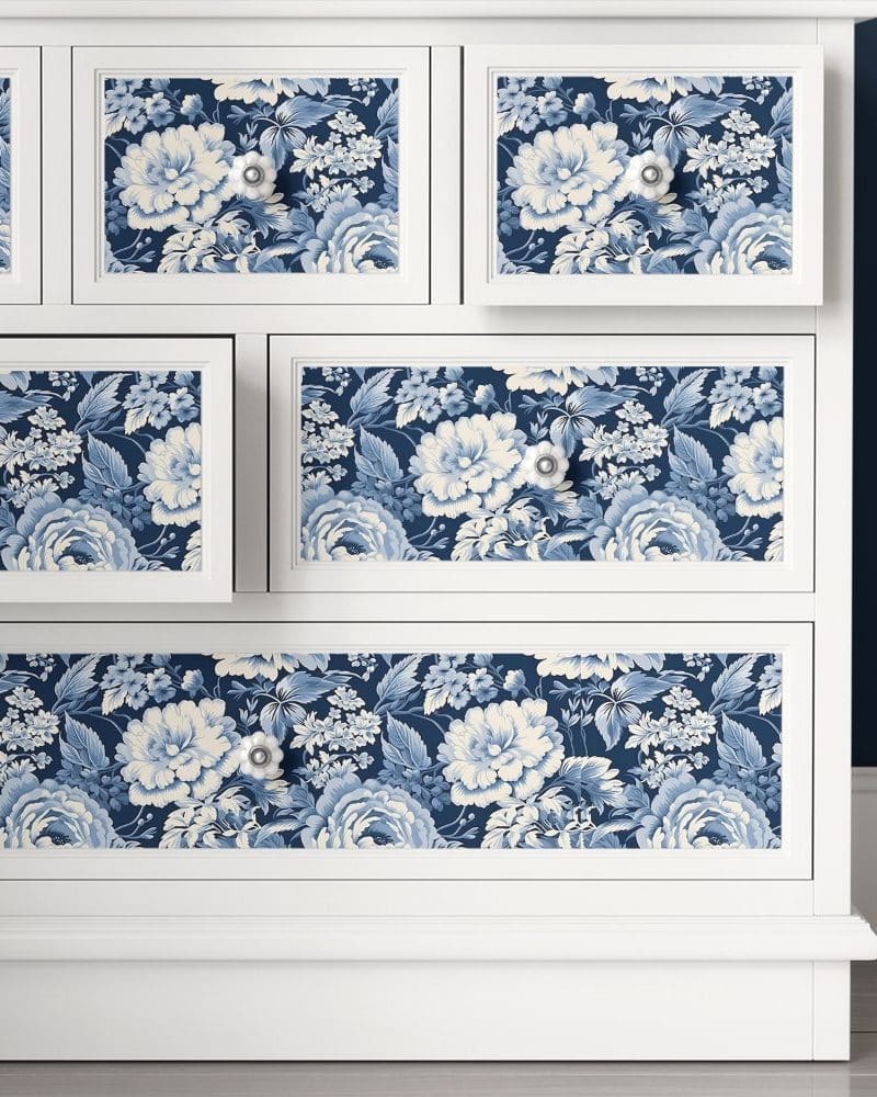 White dresser with blue and white floral drawer fronts.