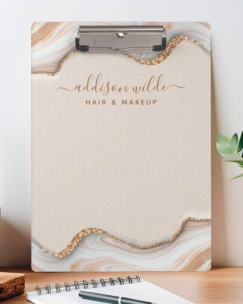 Beige clipboard with a marble and glitter design, featuring the name Addison Wilde Hair & Makeup.