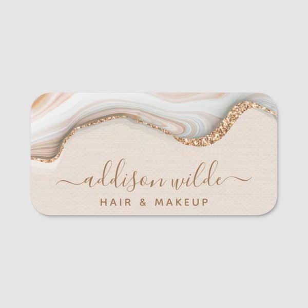 Business Card For Addison Wilde Hair &Amp; Makeup Featuring A Beige Background, Gold Glitter Accents, And A Marble Design.