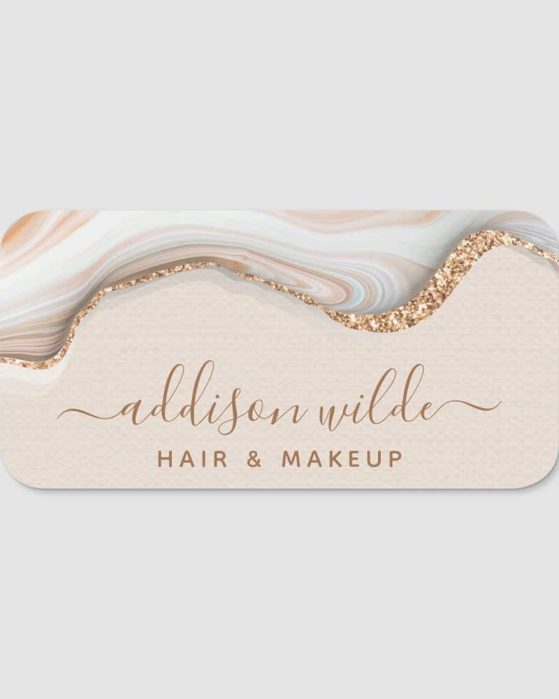 Business card for Addison Wilde Hair & Makeup featuring a beige background, gold glitter accents, and a marble design.