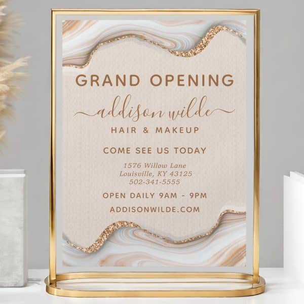Gold Stand-Up Sign Announcing The Grand Opening Of Addison Wilde Hair &Amp; Makeup, Including Address, Phone Number, And Website.