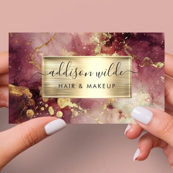 Business Card For Addison Wilde Hair &Amp; Makeup, Featuring A Burgundy And Gold Marble Design.