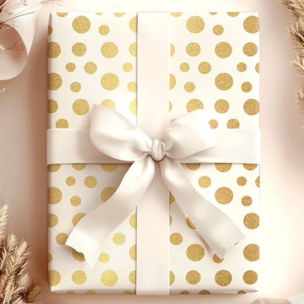 A Gift Wrapped In White Paper With Gold Polka Dots And Tied With A Large White Ribbon.