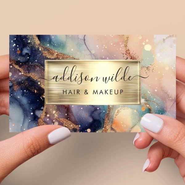 Business Card For Addison Wilde Hair &Amp; Makeup, Featuring An Abstract Watercolor Design In Blues, Pinks, And Gold.