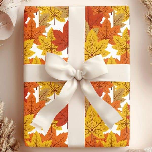 A Gift Wrapped In Autumn-Themed Wrapping Paper Featuring Orange And Yellow Leaves, Tied With A Cream-Colored Ribbon.