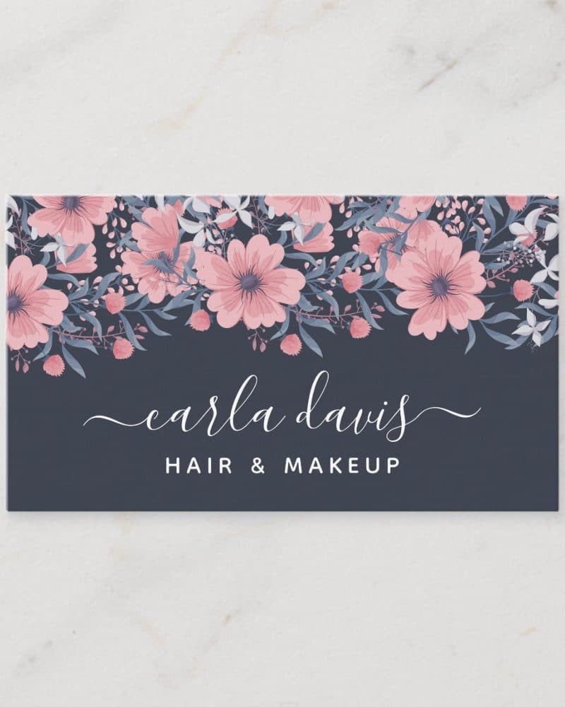 Floral business card for Carla Davis, Hair & Makeup. Pink and blue flowers across the top.