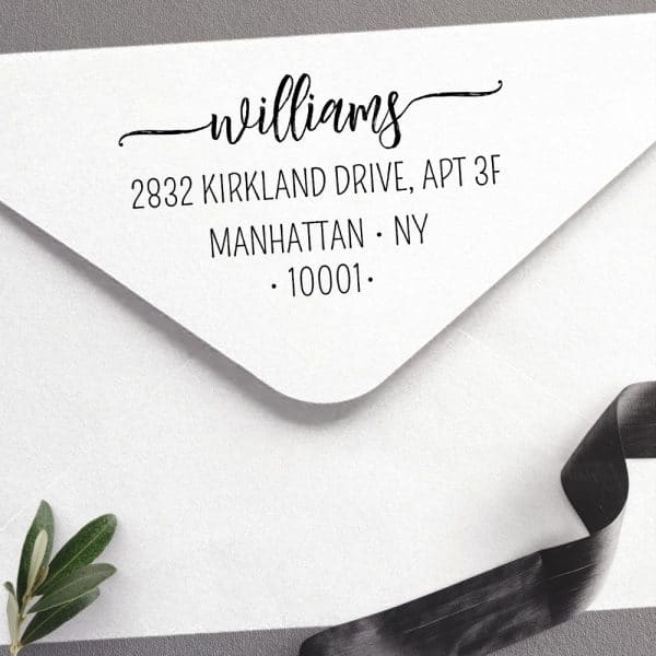 Return Address Stamp Showing The Williams Family Name, Address, And Zip Code On A White Envelope.