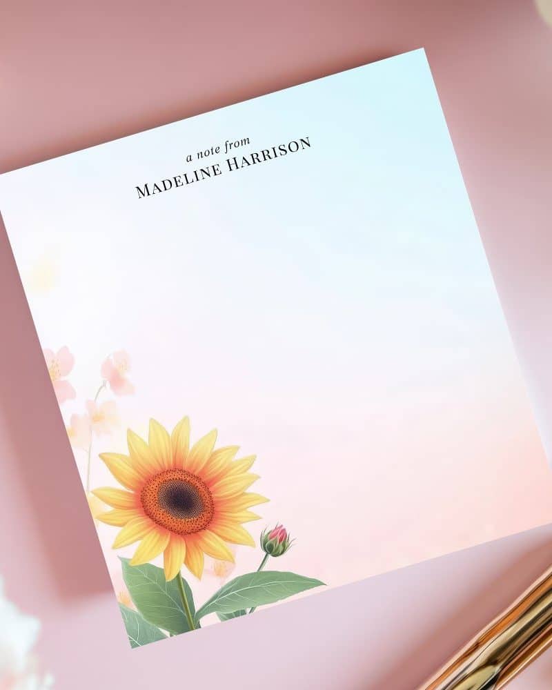 Personalized stationery featuring a sunflower and other flowers on a pastel background.