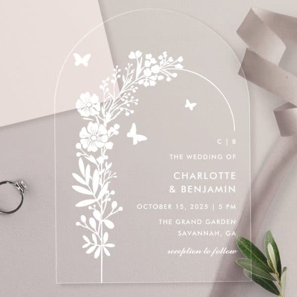 Clear Acrylic Wedding Invitation With Floral Design And Butterflies. Charlotte And Benjamin'S Wedding Details Are Printed On The Card.