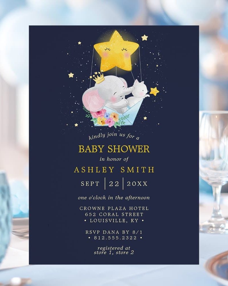 Baby shower invitation featuring a cute illustration of an elephant and cat riding in a hot air balloon-shaped star.