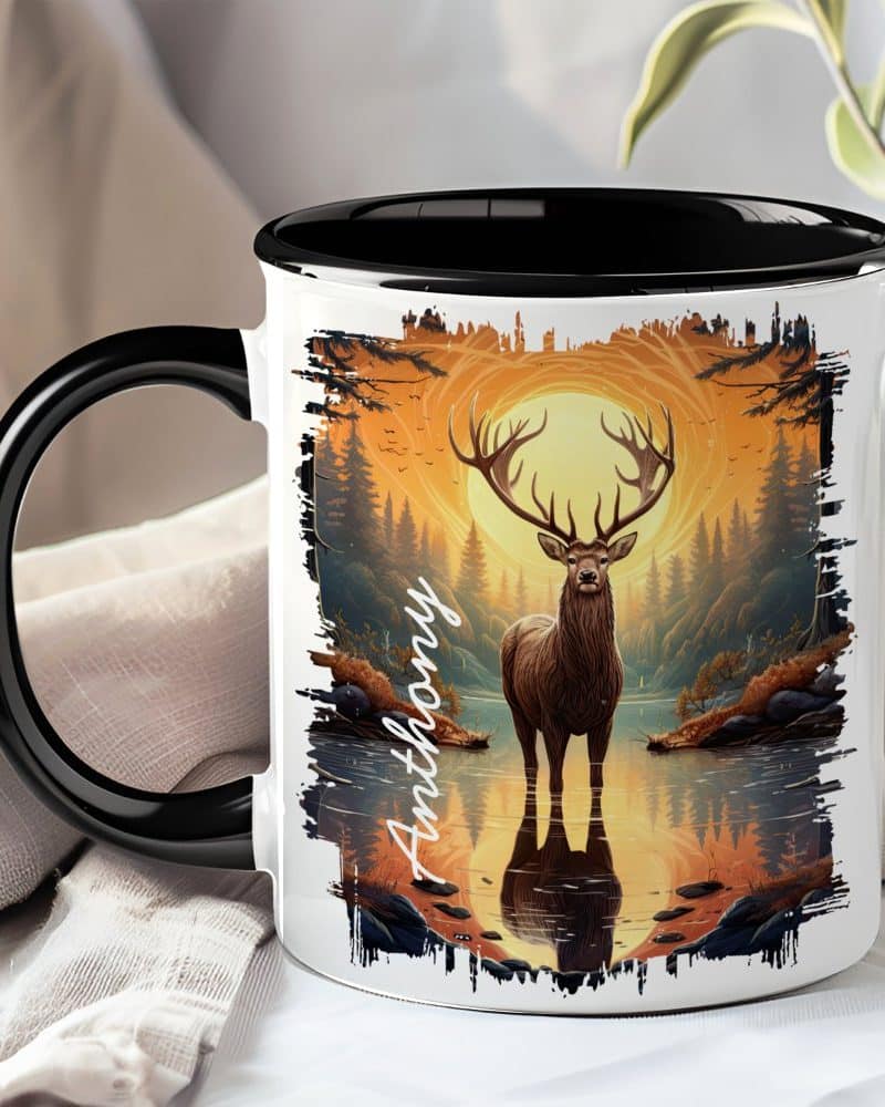 Black-handled mug with a personalized name, Anthony, and a graphic of a large stag standing in a forest reflecting in water at sunset.