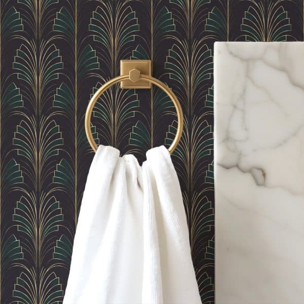 White Towel Hanging On A Gold Ring Against A Dark Art Deco Wallpaper.