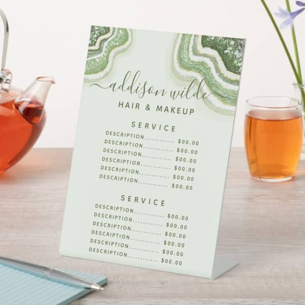 Addison Wilde Hair And Makeup Price List On A Freestanding Display.