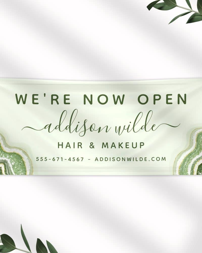 Grand opening banner for Addison Wilde Hair & Makeup. The banner is light green with a green agate design and the business name and contact information.