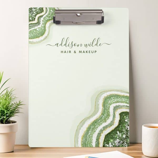 A Light Green Clipboard With A Green And White Agate Design And Addison Wilde Hair &Amp; Makeup Written On It.