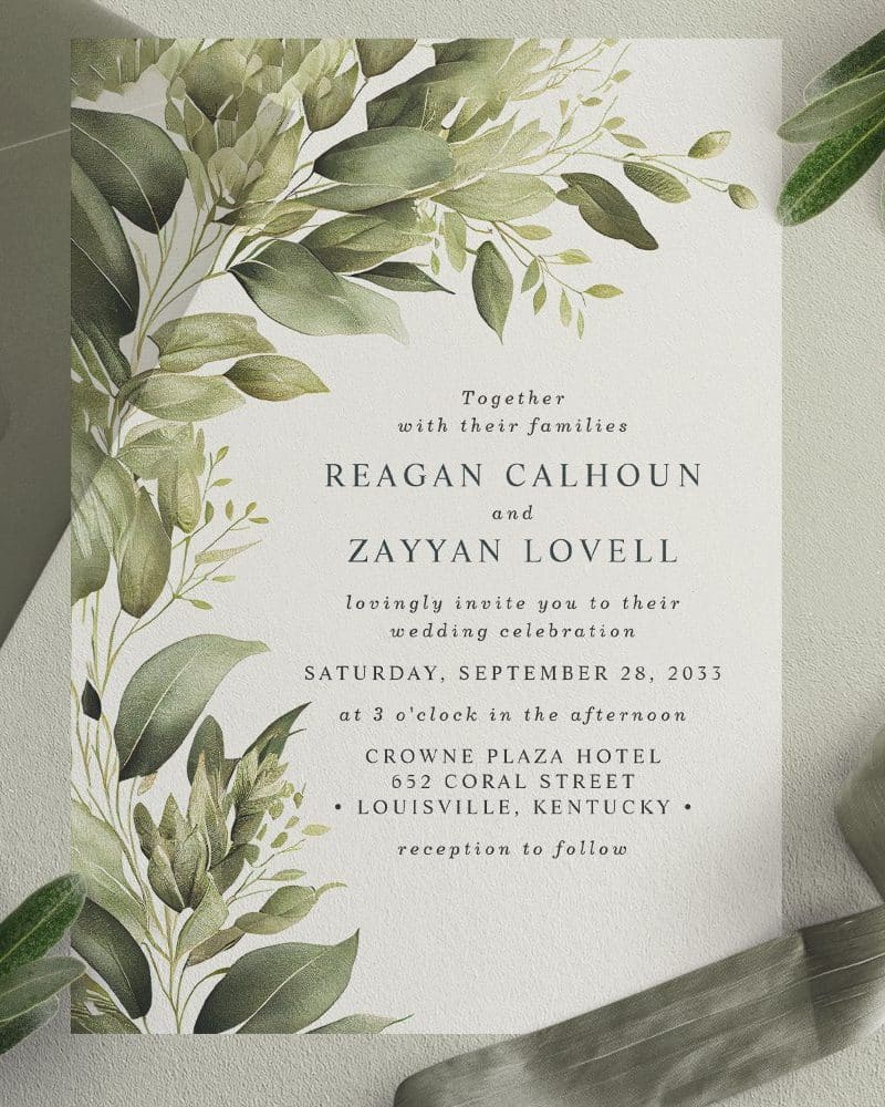 Wedding invitation with green watercolor floral design; Reagan Calhoun and Zayyan Lovell's wedding details are featured.